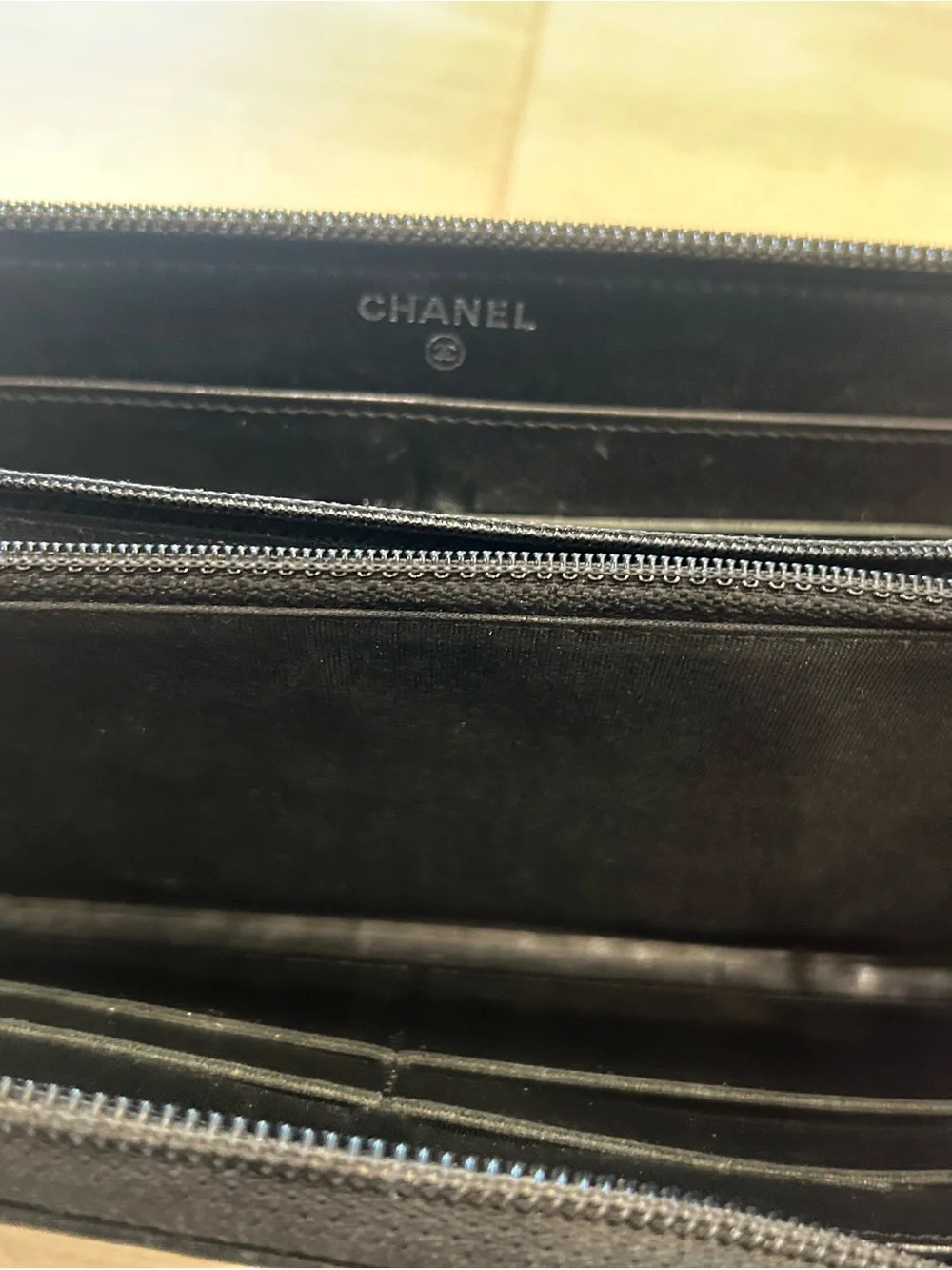 CHANEL Black Quilted Zip Around Wallet with Embossed CC
